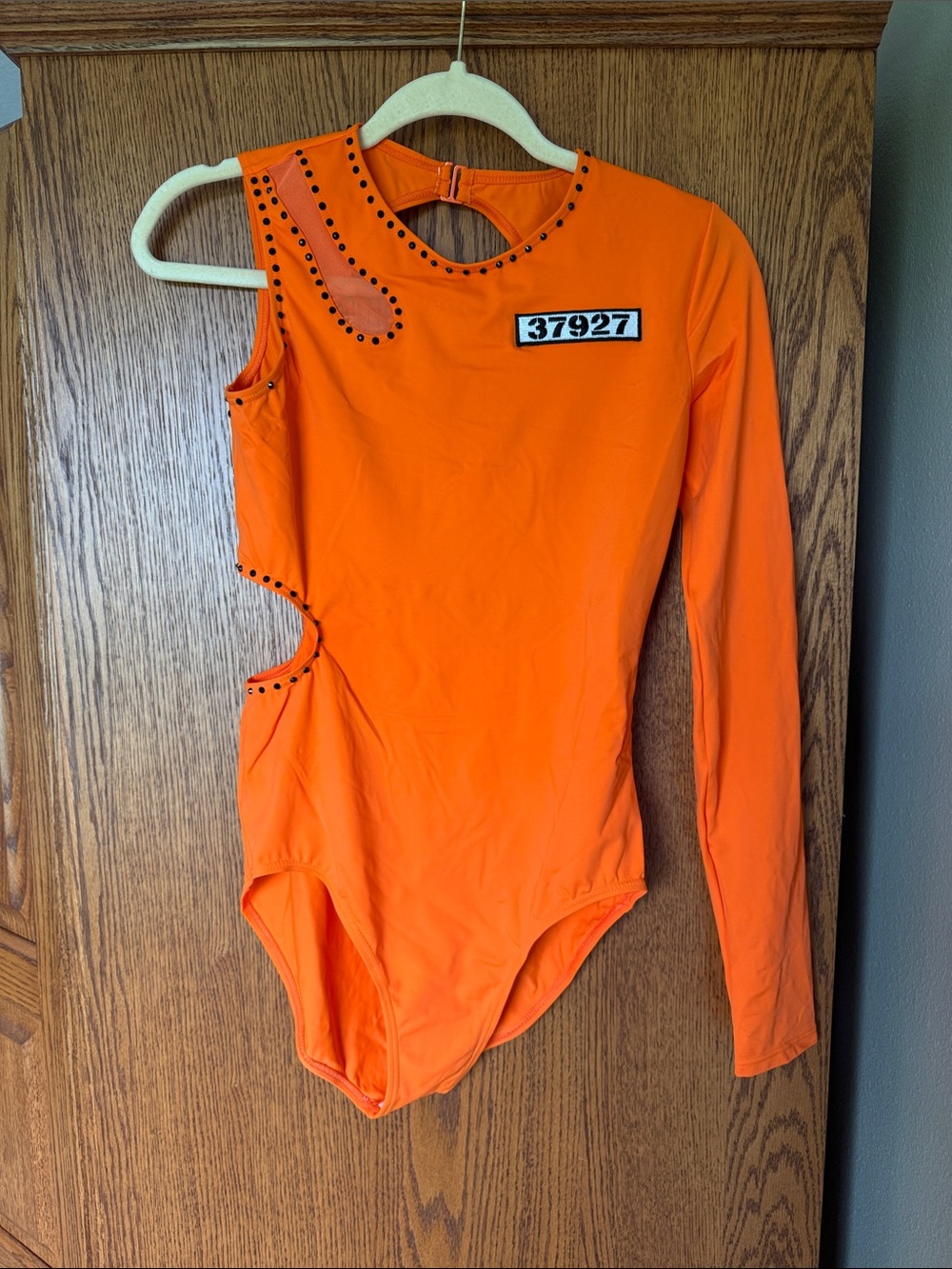 Orange One-Shoulder cutout leotard with custom patch and black stud rhinestones